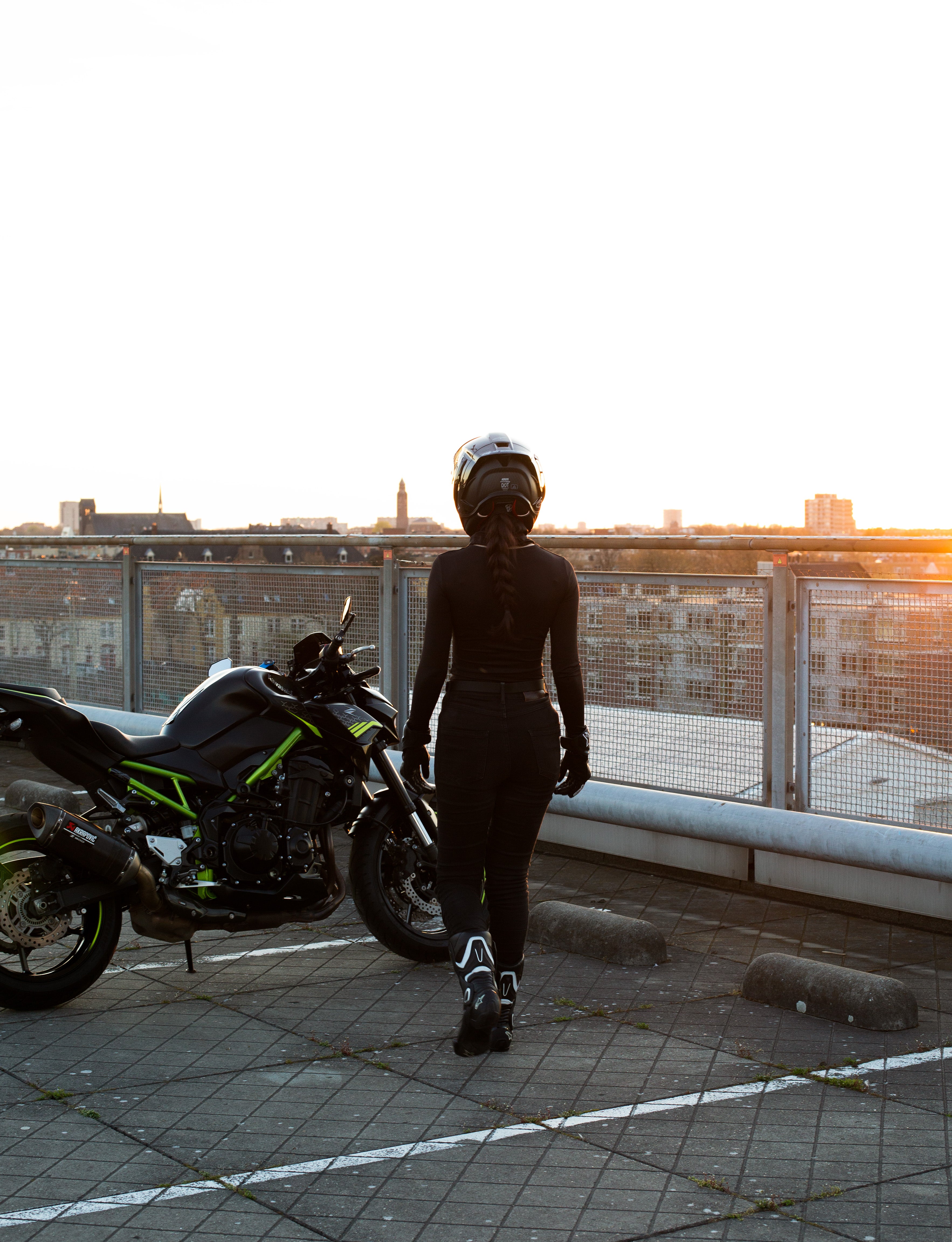 Female rider approaching motorcycle before ride