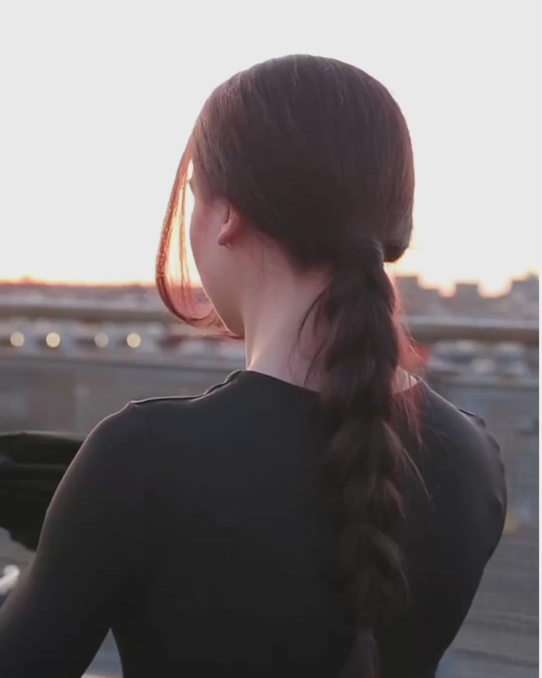 Female rider putting on BRAIDFIT BALACLAVA with braid opening